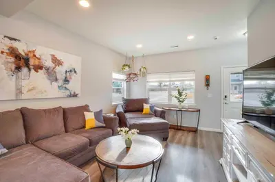 a living room with a couch and a table at Fire Pit and Shuffleboard Suburban Denver Home in Denver