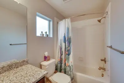 a bathroom with a toilet and a shower and a sink at Fire Pit and Shuffleboard Suburban Denver Home in Denver