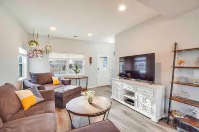 a living room with a couch and a flat screen tv at Fire Pit and Shuffleboard Suburban Denver Home in Denver