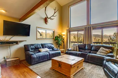 a living room with leather couches and a tv at Private Deck and Hot Tub Silverthorne Home! in Silverthorne
