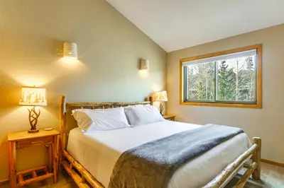 a bedroom with a large bed and a window at Private Deck and Hot Tub Silverthorne Home! in Silverthorne