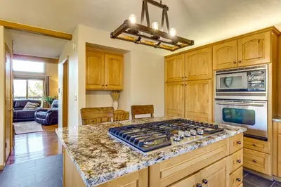 a kitchen with a stove top in the middle at Private Deck and Hot Tub Silverthorne Home! in Silverthorne