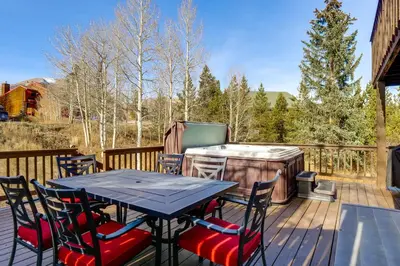 a deck with a table and chairs and a grill at Private Deck and Hot Tub Silverthorne Home! in Silverthorne