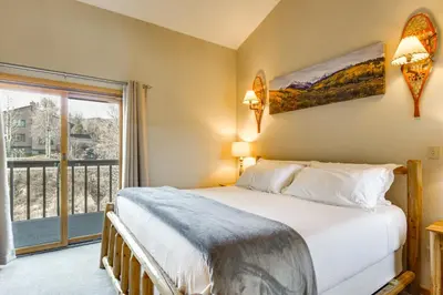 a bedroom with a bed and a large window at Private Deck and Hot Tub Silverthorne Home! in Silverthorne