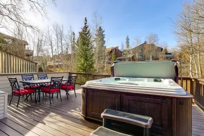 a hot tub on a deck with a table and chairs at Private Deck and Hot Tub Silverthorne Home! in Silverthorne