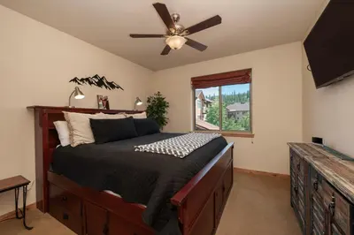 a bedroom with a bed and a ceiling fan at Trailhead Lodges 821 in Winter Park