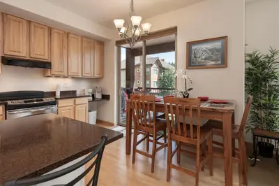 a kitchen with a table and chairs and a dining room at Trailhead Lodges 821 in Winter Park