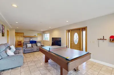 a living room with a ping pong table at Sakura House in Tabernash