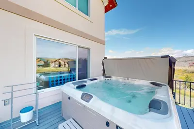 a hot tub on the balcony of a house at Sakura House in Tabernash
