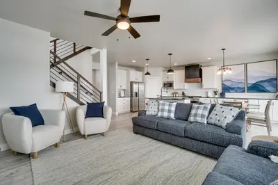 a living room with a couch and chairs and a kitchen at Family-Friendly Townhome about 2 Mi to Windsor Lake! in Windsor