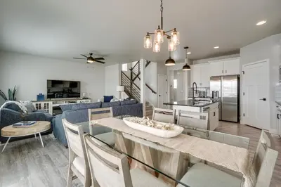 a kitchen and living room with a table and chairs at Family-Friendly Townhome about 2 Mi to Windsor Lake! in Windsor