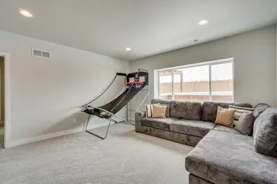 a living room with a couch and a hammock at Family-Friendly Townhome about 2 Mi to Windsor Lake! in Windsor