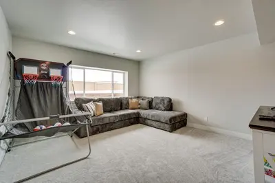 a living room with a couch and a window at Family-Friendly Townhome about 2 Mi to Windsor Lake! in Windsor