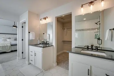 a bathroom with two sinks and a large mirror at Family-Friendly Townhome about 2 Mi to Windsor Lake! in Windsor