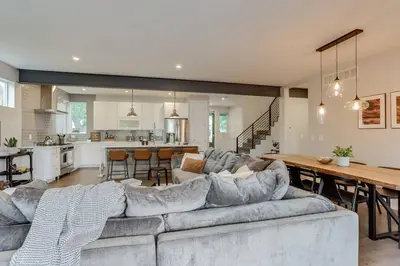 a living room and kitchen with a couch and a table at Zen Haus* Lavish Getaway w/ Gym, Sauna, Hot Tub in Denver