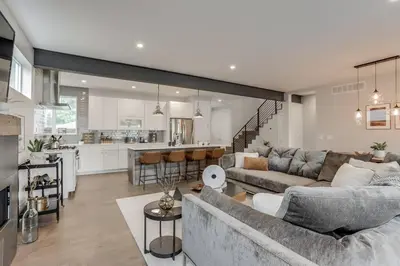 a living room with a couch and a kitchen at Zen Haus* Lavish Getaway w/ Gym, Sauna, Hot Tub in Denver