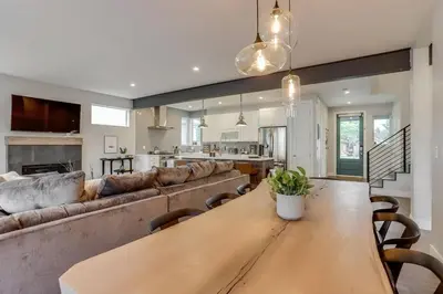 a living room with a wooden table and a couch at Zen Haus* Lavish Getaway w/ Gym, Sauna, Hot Tub in Denver