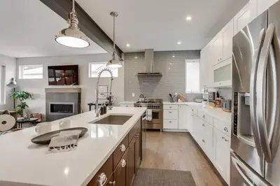 a large kitchen with white cabinets and a large island at Zen Haus* Lavish Getaway w/ Gym, Sauna, Hot Tub in Denver
