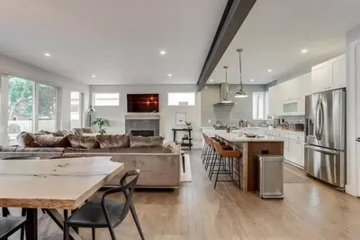 a large kitchen and living room with a large couch at Zen Haus* Lavish Getaway w/ Gym, Sauna, Hot Tub in Denver
