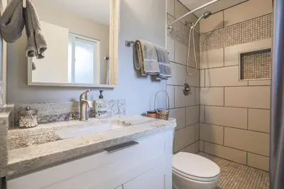 a bathroom with a sink and a toilet and a shower at Large Gorgeous House * Patio w/ Outdoor Dining in Denver