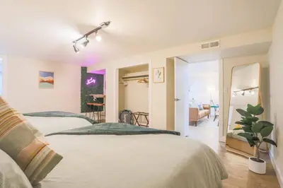 a bedroom with two beds and a living room at Large Gorgeous House * Patio w/ Outdoor Dining in Denver