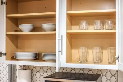 a kitchen cabinet with plates and glasses in it at Large Gorgeous House * Patio w/ Outdoor Dining in Denver
