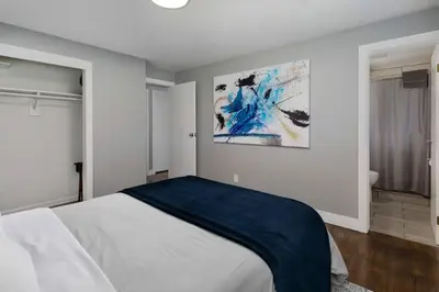 a bedroom with a bed with a blue blanket on it at NEW Modern Home w/ Beautiful Finishes! in Denver