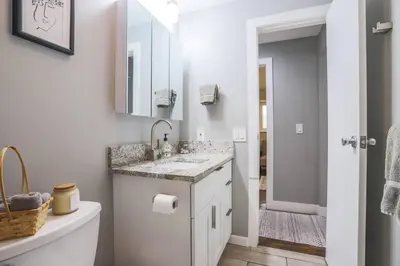 a white bathroom with a sink and a mirror at NEW Modern Home w/ Beautiful Finishes! in Denver