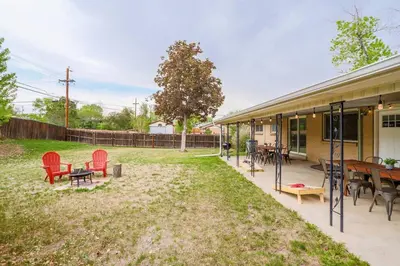 a patio with red chairs and tables in a yard at NEW! Gorgeous Colorado Getaway * Glamping Vibes * in Denver