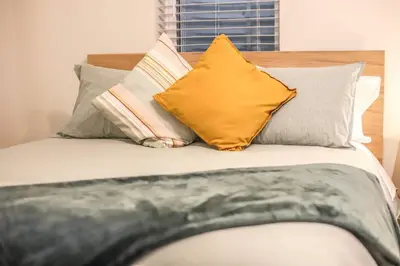 a bed with several pillows on top of it at NEW! Gorgeous Colorado Getaway * Glamping Vibes * in Denver