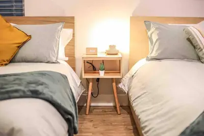 a bedroom with two beds and a small table with a night stand at NEW! Gorgeous Colorado Getaway * Glamping Vibes * in Denver