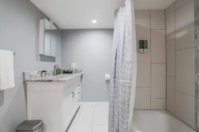 a white bathroom with a shower and a sink at NEW! Gorgeous Colorado Getaway * Glamping Vibes * in Denver