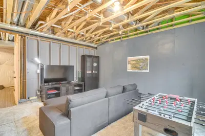 a living room with a couch and a table and a tv at Cozy Colorado Home with Putting Green Near Loveland! in Loveland