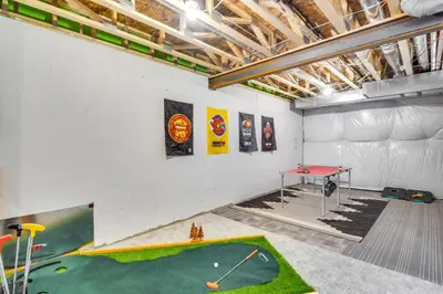 a room with a golf course on the wall at Cozy Colorado Home with Putting Green Near Loveland! in Loveland