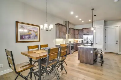 a kitchen and dining room with a table and chairs at Cozy Colorado Home with Putting Green Near Loveland! in Loveland