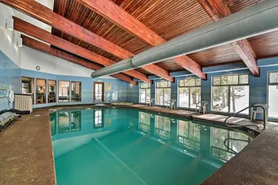 a swimming pool in a house with a ceiling at Winter Park Condo Rental about 2 Mi to Ski Resort! in Winter Park