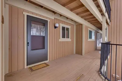 a front door of a house with a porch at Winter Park Condo Rental about 2 Mi to Ski Resort! in Winter Park