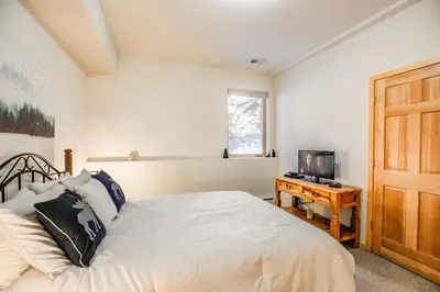a bedroom with a bed and a table with a television at Windflower Retreat: Beautiful Dog Friendly Home in Frisco