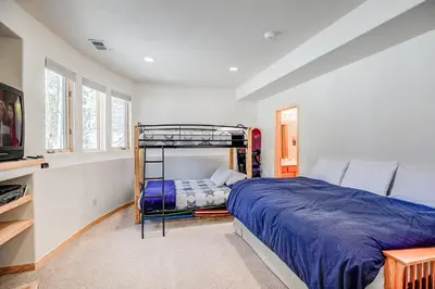 a bedroom with a bunk bed and a tv at Windflower Retreat: Beautiful Dog Friendly Home in Frisco