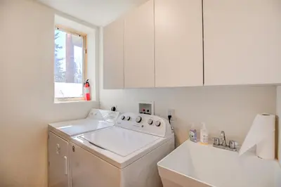 a white laundry room with a washing machine and a window at Windflower Retreat: Beautiful Dog Friendly Home in Frisco