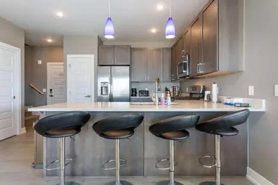 a kitchen with black stools at a kitchen counter at Sail Lofts at Lake Dillon 304 in Dillon