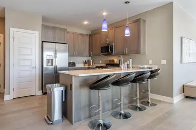 a kitchen with a counter and bar stools at Sail Lofts at Lake Dillon 304 in Dillon