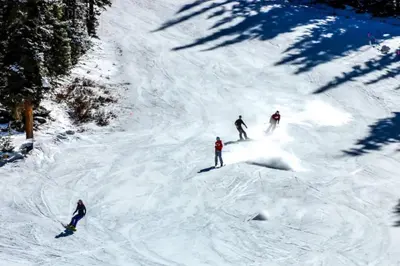 a group of three people skiing down a snow covered slope at Sail Lofts at Lake Dillon 304 in Dillon