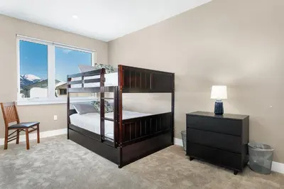a bedroom with a bunk bed with a desk and a chair at Sail Lofts at Lake Dillon 304 in Dillon