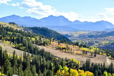 a mountain with trees and mountains in the background at Liftside 104 - Keystone in Keystone