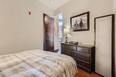 a bedroom with a bed and a dresser and a mirror at 2Bed 2Ba Loft in LoDo RiNo- Mountain BallparkViews in Denver