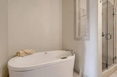 a white bathroom with a toilet and a shower at 2Bed 2Ba Loft in LoDo RiNo- Mountain BallparkViews in Denver