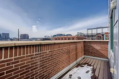 a brick wall with snow on a balcony at 2Bed 2Ba Loft in LoDo RiNo- Mountain BallparkViews in Denver