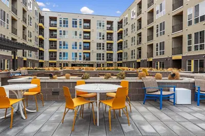 a patio with tables and chairs and buildings at Kasa Rino Denver in Denver