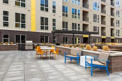 a patio with chairs and tables and a table and chairs at Kasa Rino Denver in Denver